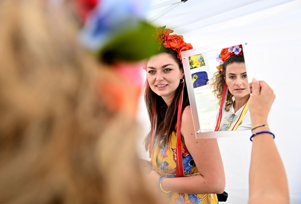 Dasha Orlova tries on a flower crown, a traditional Ukrainian headwear