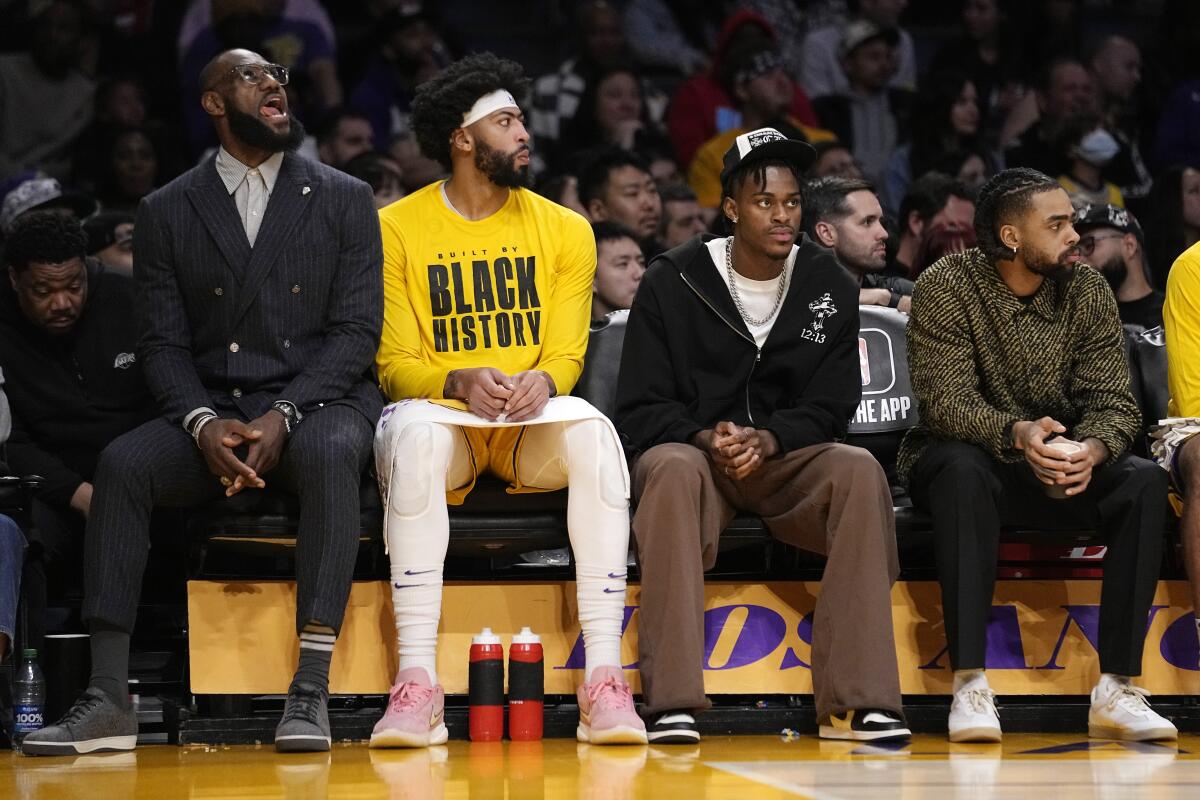 LeBron James sits on the bench with forward Anthony Davis, Jarred Vanderbilt and D'Angelo Russell.