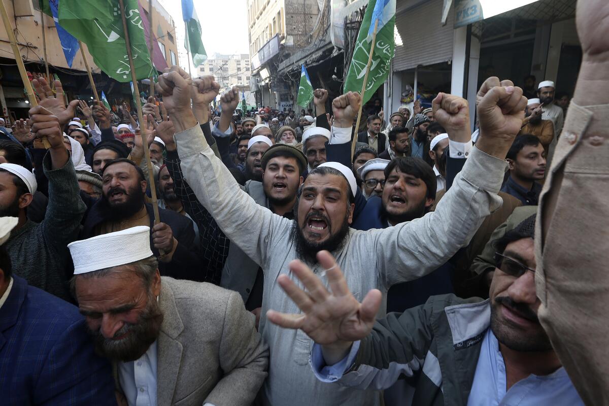 Supporters of Jamaat-e-Islami chant slogans during a protest against the burning of the Quran