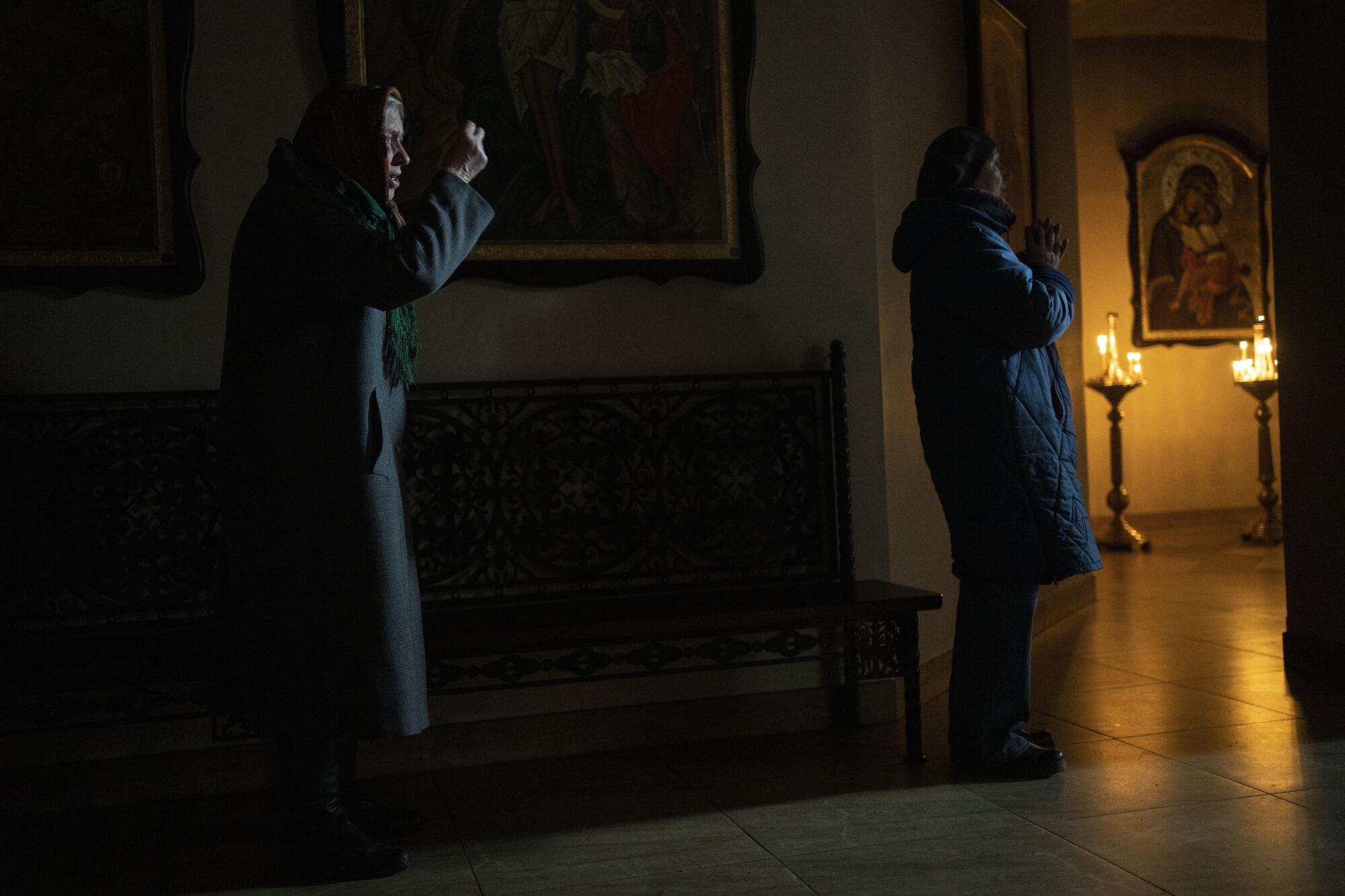 Women pray in a church.