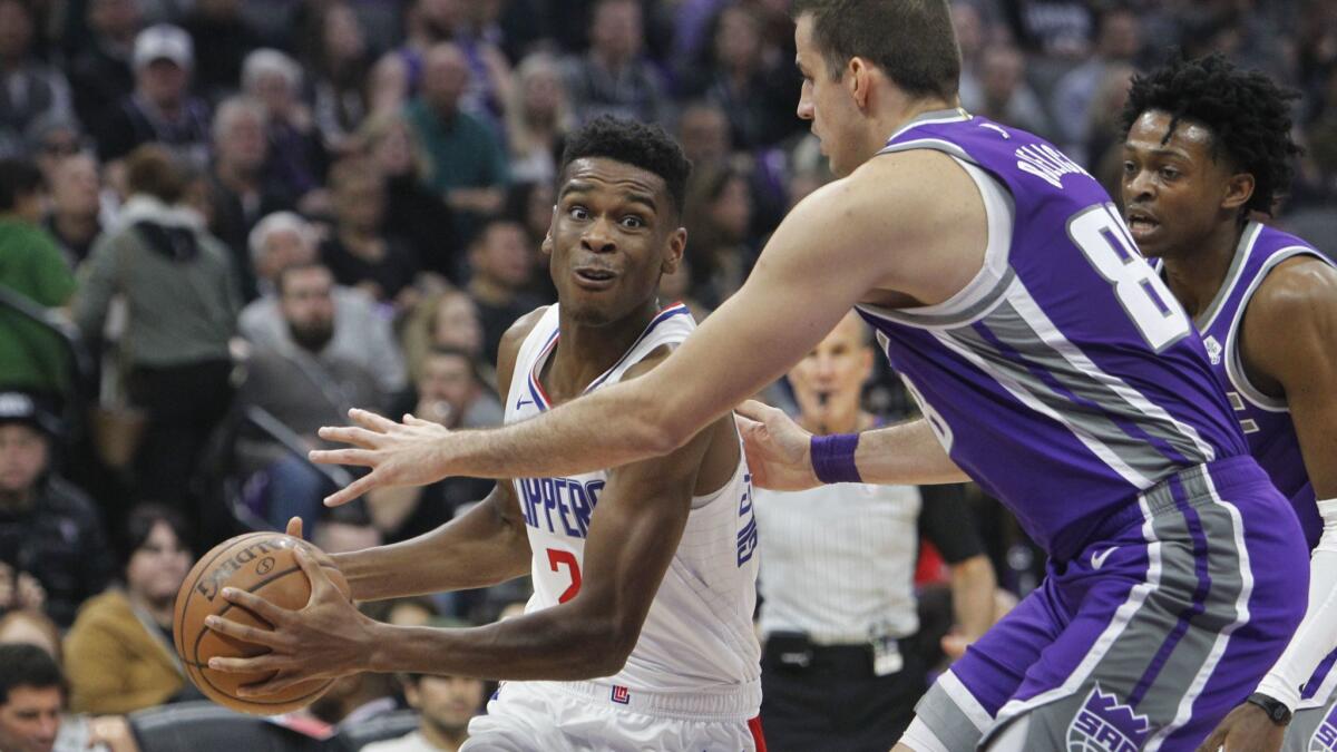 Clippers guard Shai Gilgeous-Alexander (2) drives to the basket against Sacramento Kings forward Nemanja Bjelica (88) during the first half.