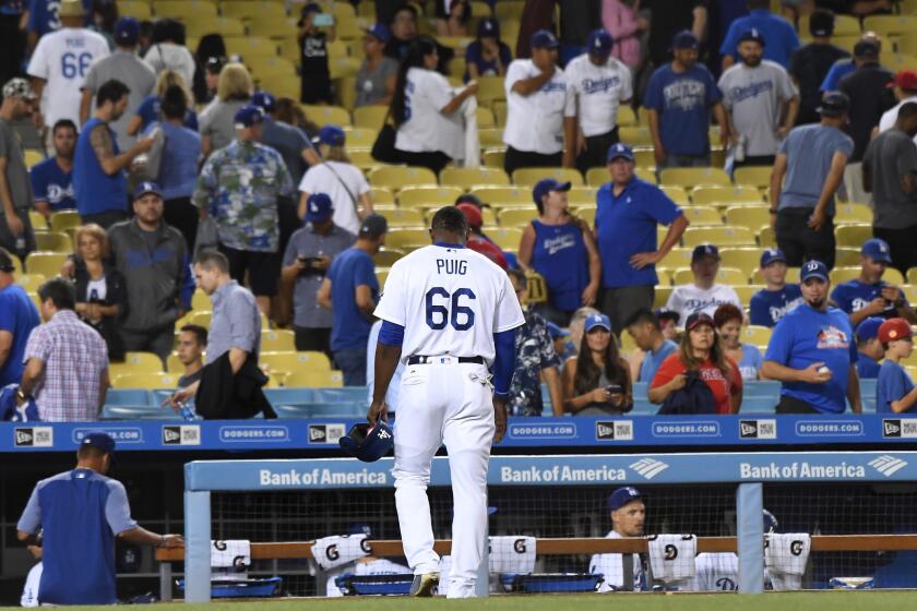 Dodgers Yasiel Puig walks off the field after hitting into a double play to end the game against the Angels.