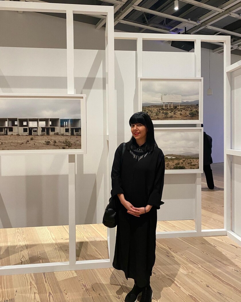 Mónica Arreola next to her photographs at Whitney Biennial 2022: Quiet As It's Kept in New York.