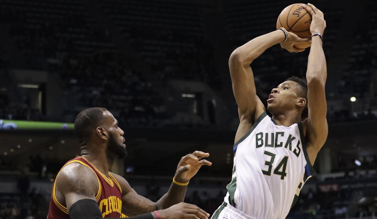 Milwaukee Bucks' Giannis Antetokounmpo shoots over Cleveland Cavaliers' LeBron James during the second half of a game Tuesday.