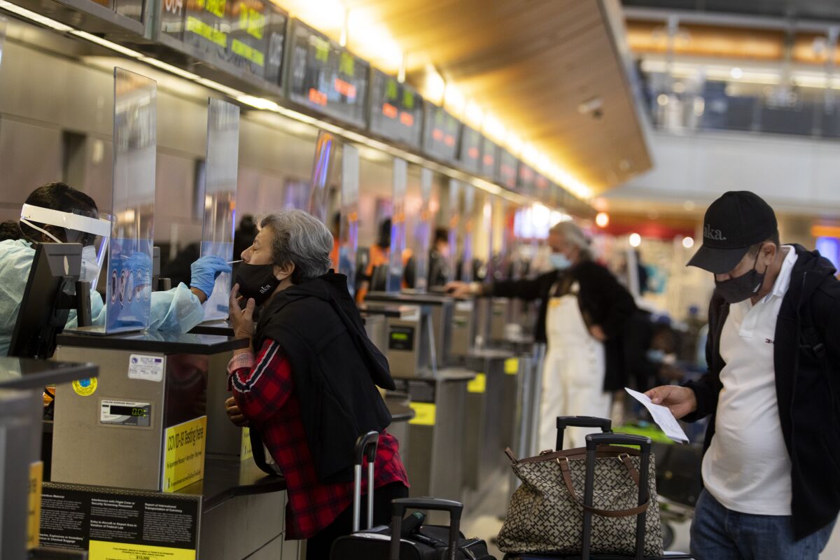 Passenger Ana Ramos is given a coronavirus test at LAX on Tuesday.