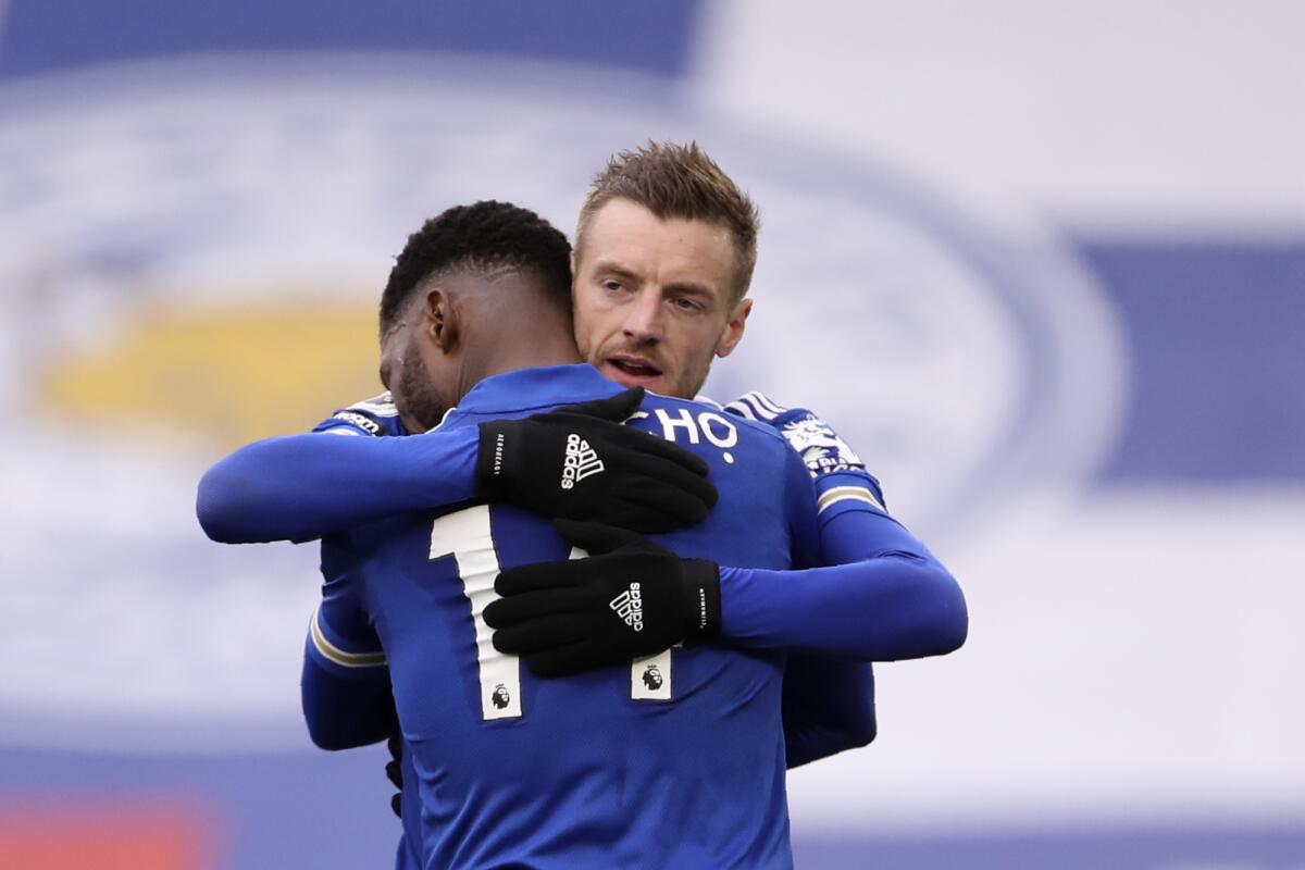 Leicester's Kelechi Iheanacho celebrates with Jamie Vardy, right, after scoring the opening goal during the English Premier League soccer match between Leicester City and Sheffield United at the King Power Stadium in Leicester, England, Sunday, March 14, 2021. (Alex Pantling/Pool via AP)