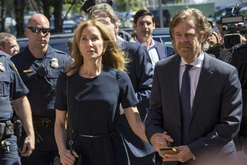 Actress Felicity Huffman, escorted by her husband William H. Macy, makes her way to the entrance of the John Joseph Moakley United States Courthouse September 13, 2019 in Boston, where she will be sentenced for her role in the College Admissions scandal. - Huffman, one of the defendants charged in the college admissions cheating scandal, is scheduled to be sentenced for paying $15,000 to inflate her daughters SAT scores, a crime she said she committed trying to be a good parent. (Photo by Joseph Prezioso / AFP)JOSEPH PREZIOSO/AFP/Getty Images ** OUTS - ELSENT, FPG, CM - OUTS * NM, PH, VA if sourced by CT, LA or MoD **