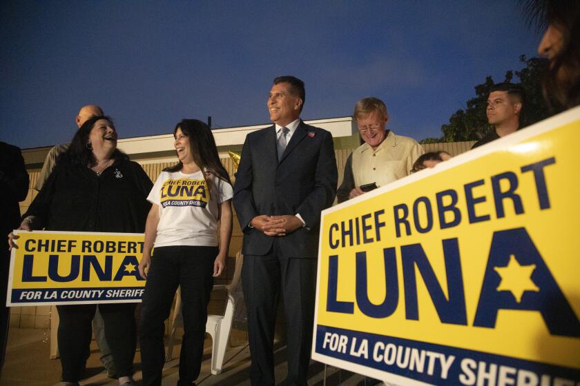 LONG BEACH, CA - JUNE 07: Retired Long Beach Police Chief Robert Luna, center, and his wife Celines celebrate election night with supporters at his home in Long Beach. Luna is running against Los Angeles County Sheriff Alex Villanueva. Photographed on Tuesday, June 7, 2022 in Long Beach, CA. (Myung J. Chun / Los Angeles Times)