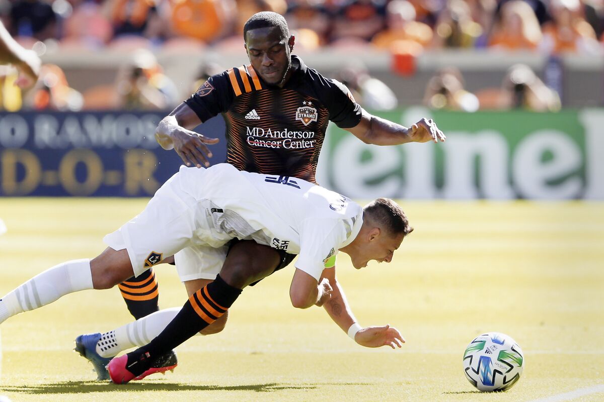 Galaxy forward Javier "Chicharito" Hernandez falls while getting tangled up with Houston Dynamo defender Maynor Figueroa.