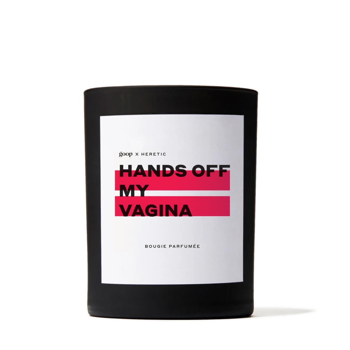 A round black candle with a white label that reads "Hands Off My Vagina."