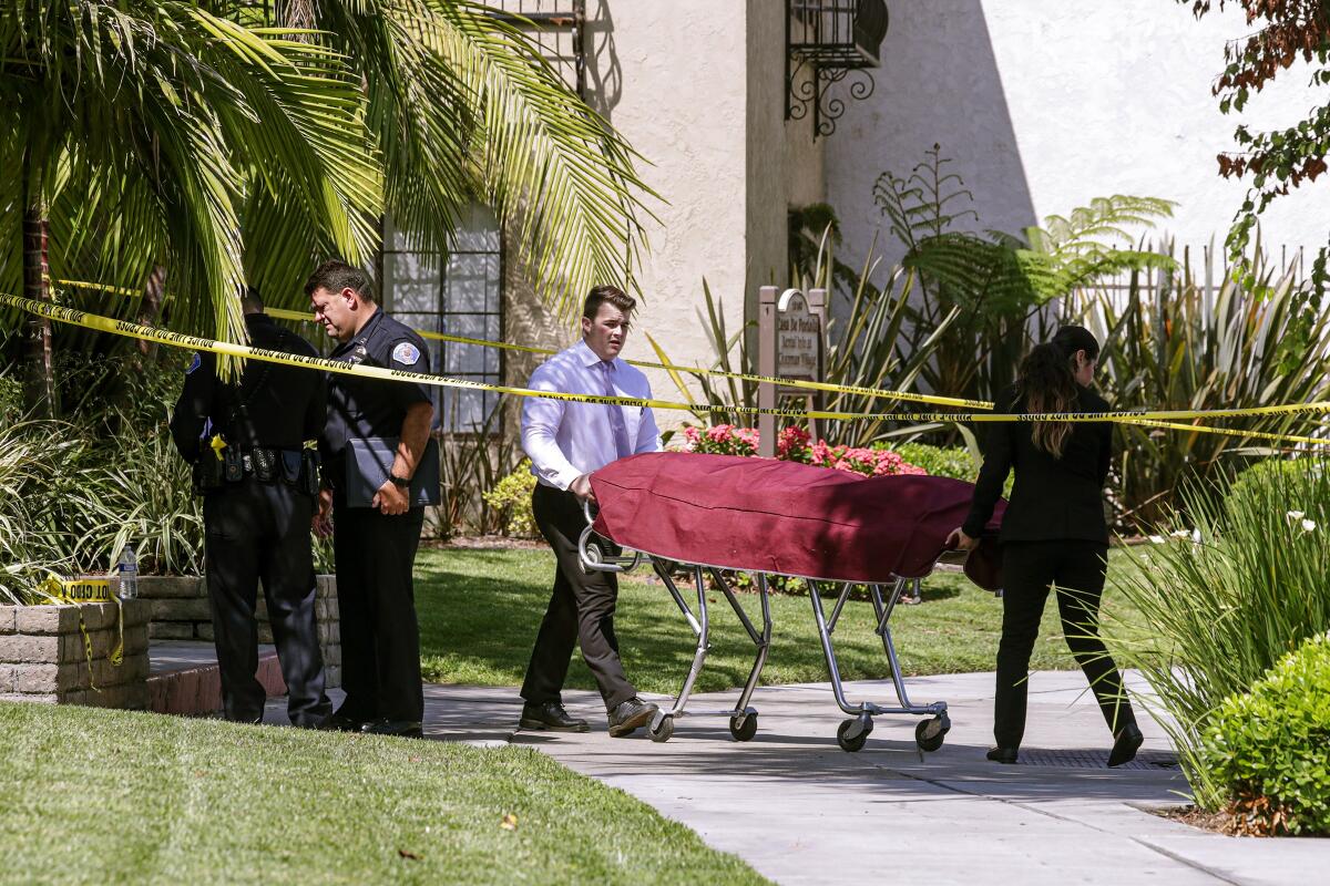 The body of one victim is taken out of the Casa De Portola apartments in Garden Grove.