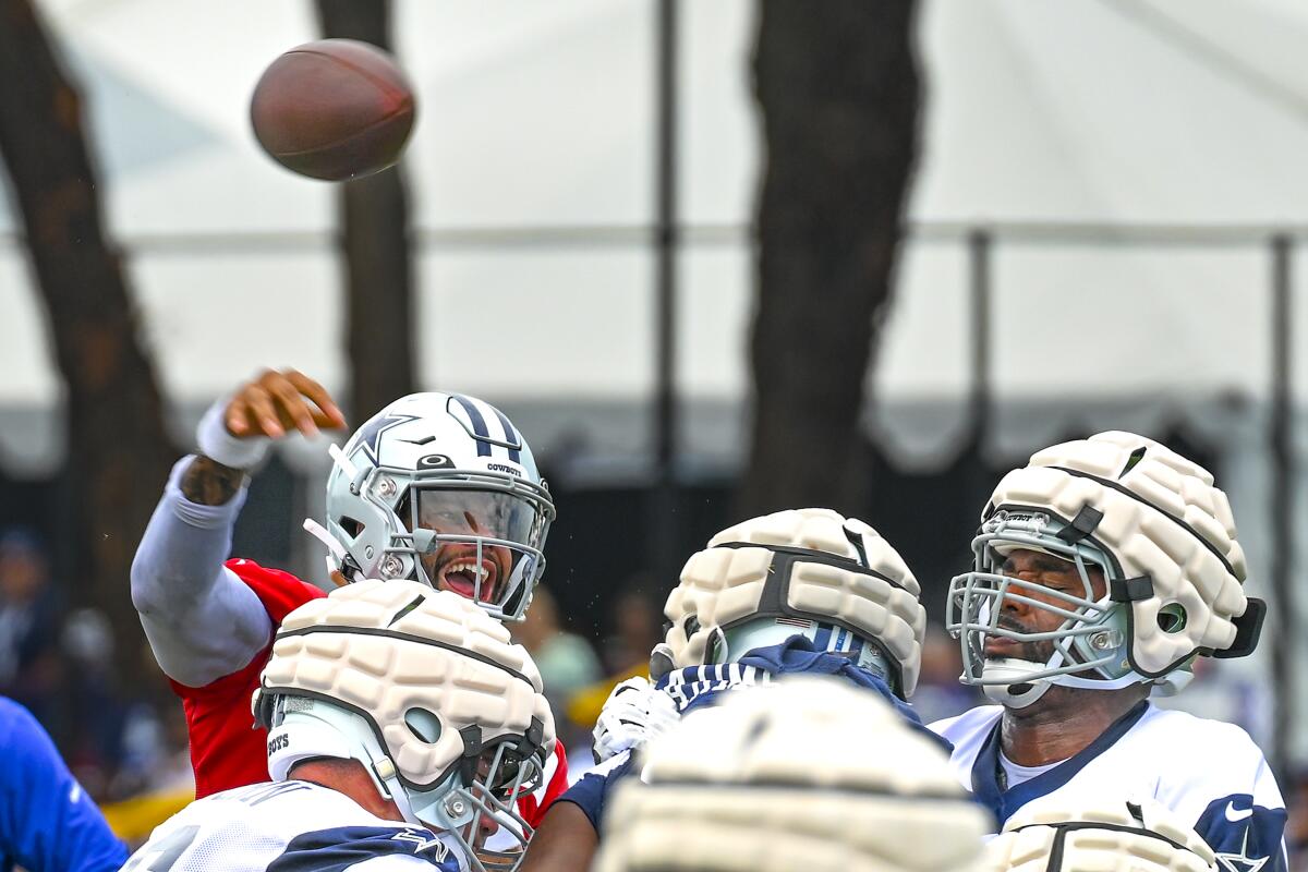 Dallas Cowboys quarterback Dak Prescott throws a pass during NFL football training camp Saturday, July 30, 2022, in Oxnard, Calif. (AP Photo/Gus Ruelas)