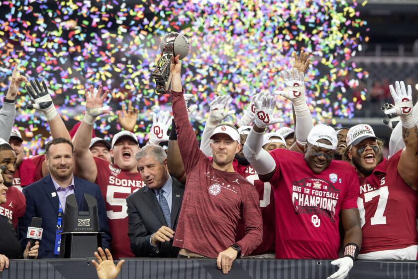 Oklahoma head coach Lincoln Riley hosts the Big 12 Conference championship trophy after defeating Baylor 30-23 in overtime in an NCAA college football game, Saturday, Dec. 7, 2019, in Arlington, Texas. (AP Photo/Jeffrey McWhorter)