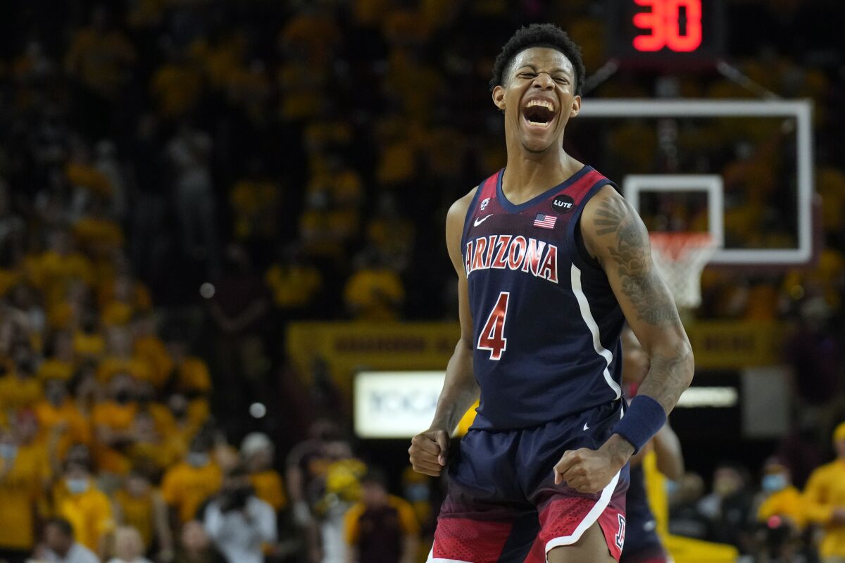 Arizona guard Dalen Terry reacts after scoring against Arizona State during the first half of an NCAA college basketball game, Monday, Feb. 7, 2022, in Tempe, Ariz. (AP Photo/Rick Scuteri)