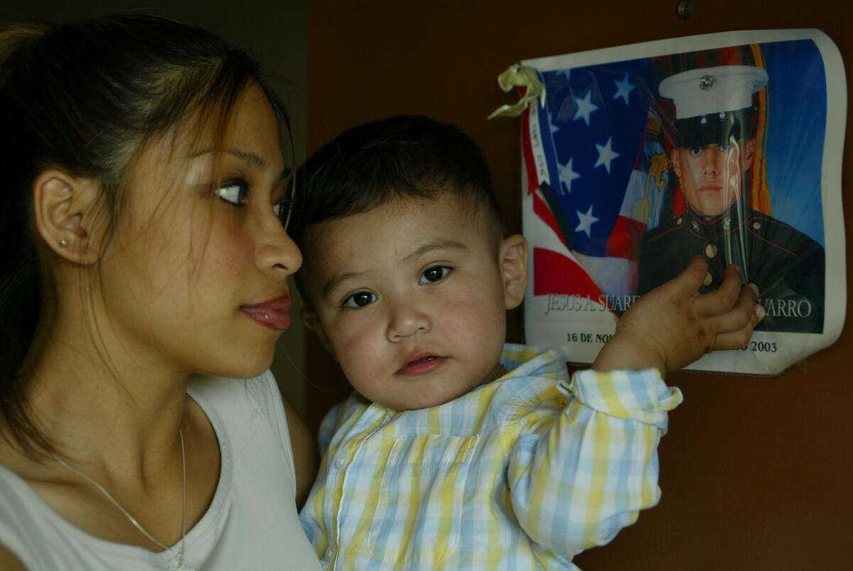 Sayne Rojas, the widow of Jesus del Solar, with their son, Erik. (Allen J. Schaben / Los Angeles Times)