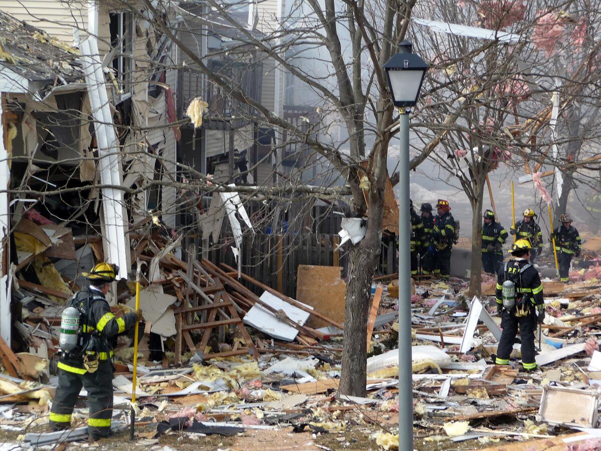 Firefighters work at the scene after an explosion at a townhouse complex Tuesday in Ewing, N.J.