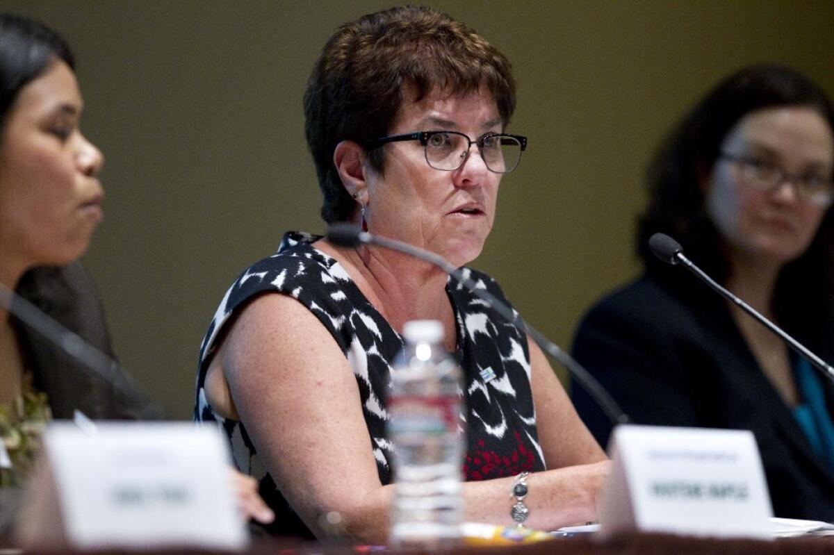 Shelley Rouillard, director of the Department of Managed Health Care, is at odds with Blue Shield over a key condition she negotiated with the company last month. Above, she speaks at a Blue Shield hearing in June.