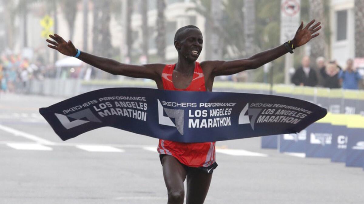 Elisha Barno crosses the finish line in Santa Monica to win the 32nd annual L.A. Marathon men's race.