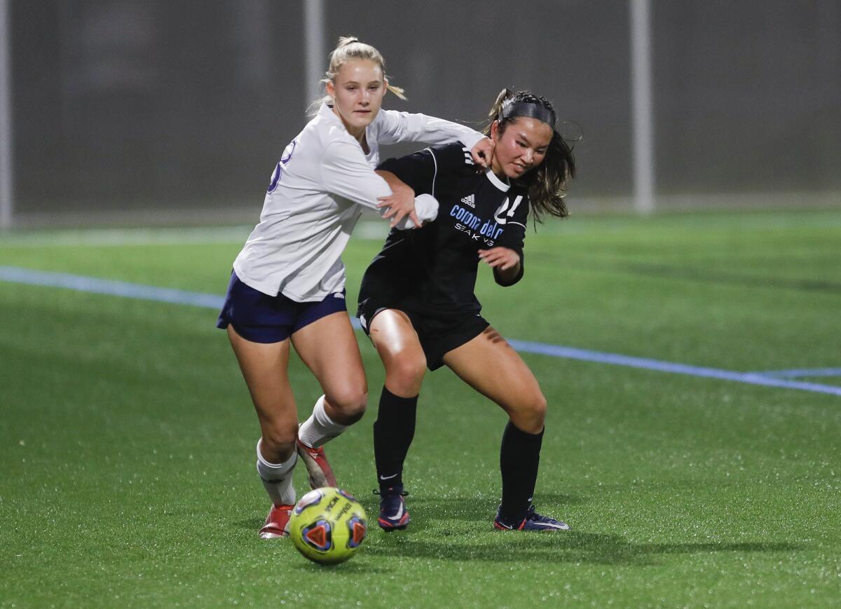 Newport Harbor's Alexis Thomas and CdM's Payton Vovan (24) get tangled up during Thursday's match.