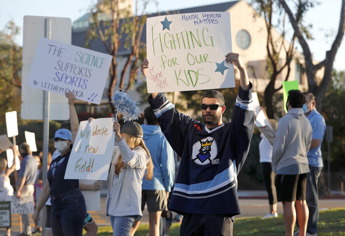 Hockey player Christian Brown participates in the statewide "Let Them Play" rally at Corona del Mar High on Friday.