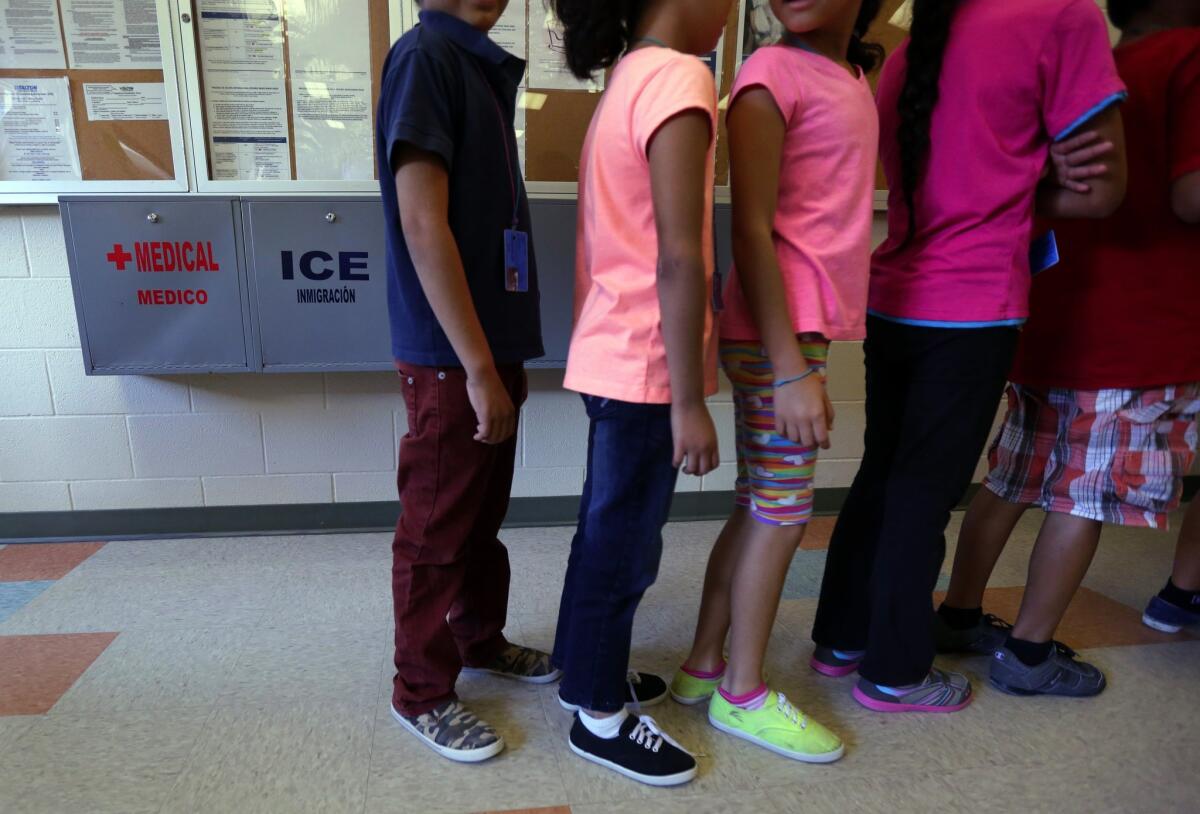 Children line up in the cafeteria at the immigration detention center in Karnes City, Texas.