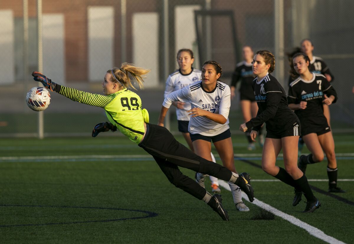 CdM goalkeeper Alex Boserup gets a hand on a ball during the annual Battle of the Bay rivalry match at CdM on Thursday.