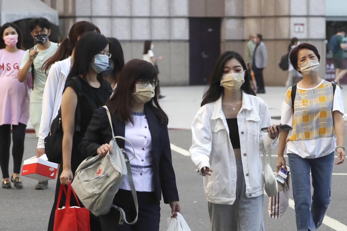 People wear face masks to protect against the spread of the coronavirus in Taipei in late August. 
