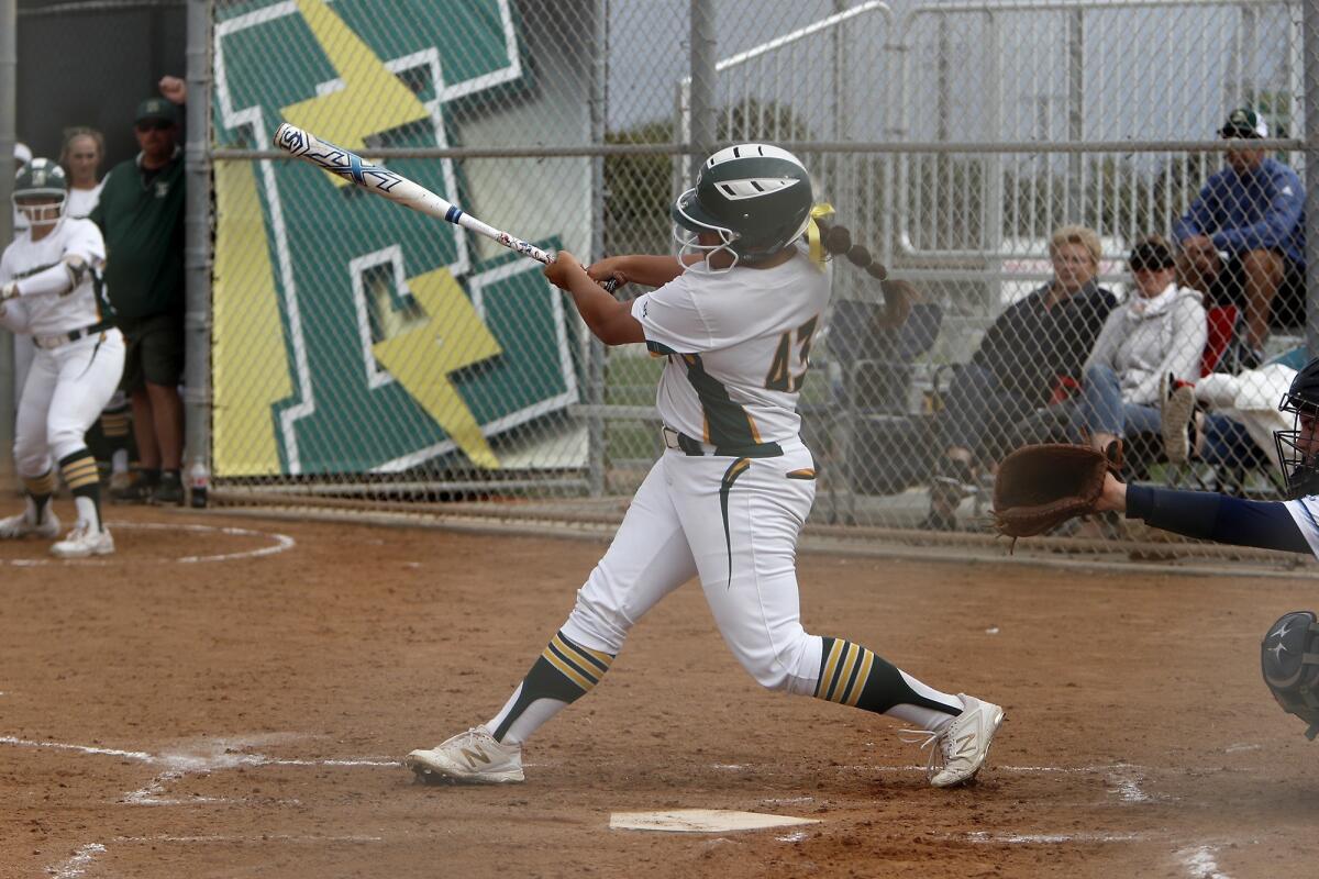 Edison's Izabella Martinez drives in a run against Marina in a Surf League game at Edison High on March 19, 2019.