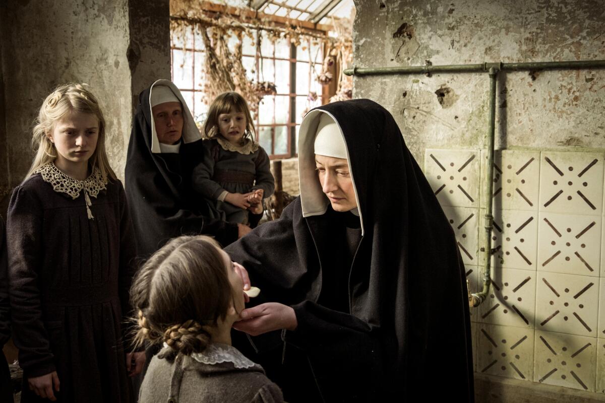 A nun puts soap in a young orphan's mouth in a scene from "Le Pupille."