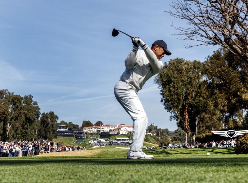 Tiger Woods hits off the ninth tee.
