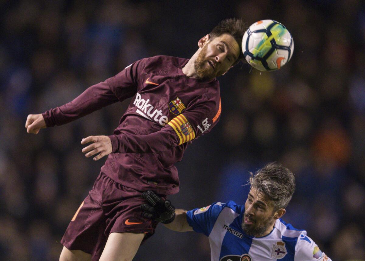Argentine Lionel Messi, left, who plays for Barcelona, vies with Deportivo's Luisinho for the ball during a soccer match in A Coruna, Spain, on April 29, 2018.