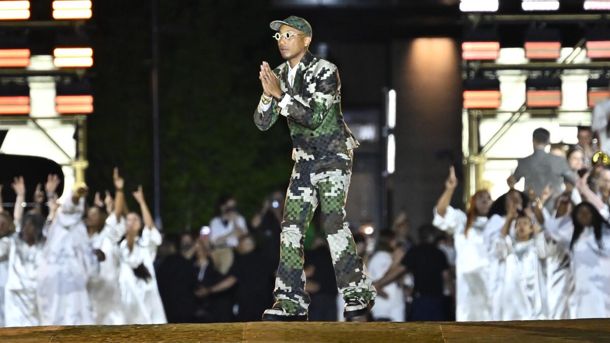 Kelly Rowland Suits Up for Pharrell's Louis Vuitton Debut Show – Footwear  News
