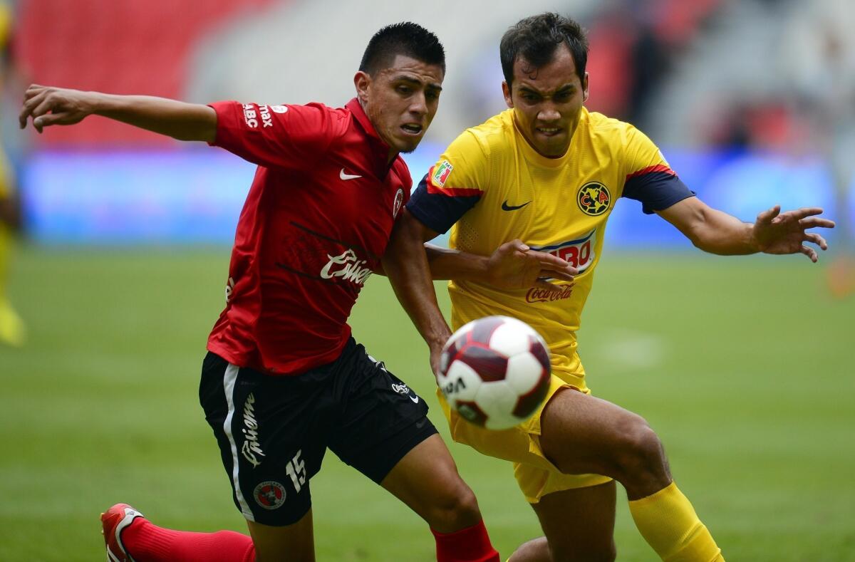 Tijuana midfielder Joe Corona, left, battles Club America defender Adrian Aldrete for the ball during a 2012 match. Corona hopes to have a strong performance in Saturday's friendly match at StubHub Center in order to improve his chances of making the U.S. World Cup team.
