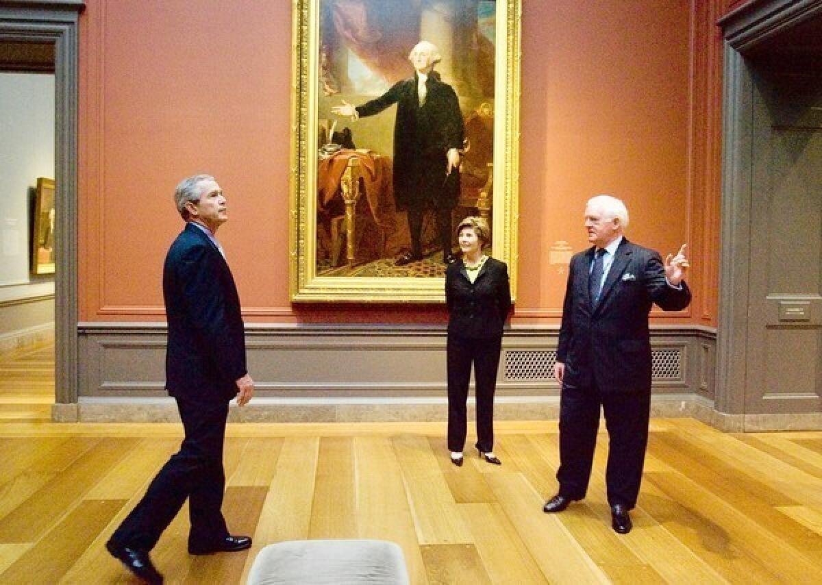 The National Gallery of Art's strong suit is not modern art. Here, then-President George W. Bush and his wife Laura receive a tour of a Gilbert Stuart exhibition at the NGA from Director Earl “Rusty” Powell, formerly of LACMA, in 2005.