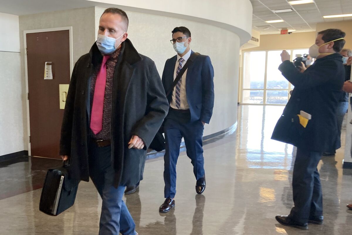 Brett Hankison, left, exits the courtroom after the first day of jury selection in his trial on Tuesday, Feb. 8, 2022, in Louisville, Ky. Hankison is on trial for allegedly firing shots into the apartment next door to Breonna Taylor's the night she was killed. (AP Photo/Dylan Lovan)