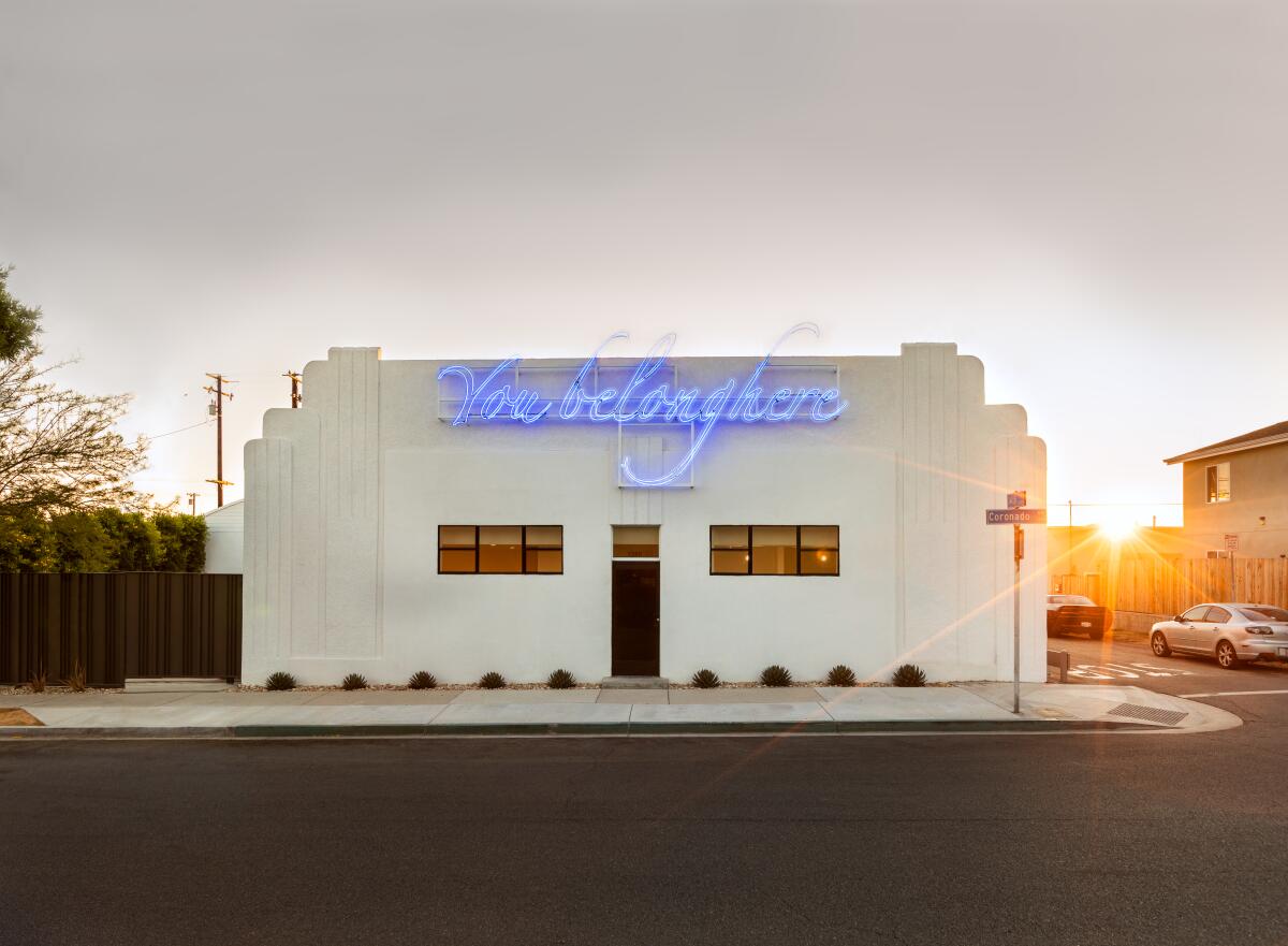Tavares Strachan's neon work reads “You Belong Here” on the facade of Compound art space.