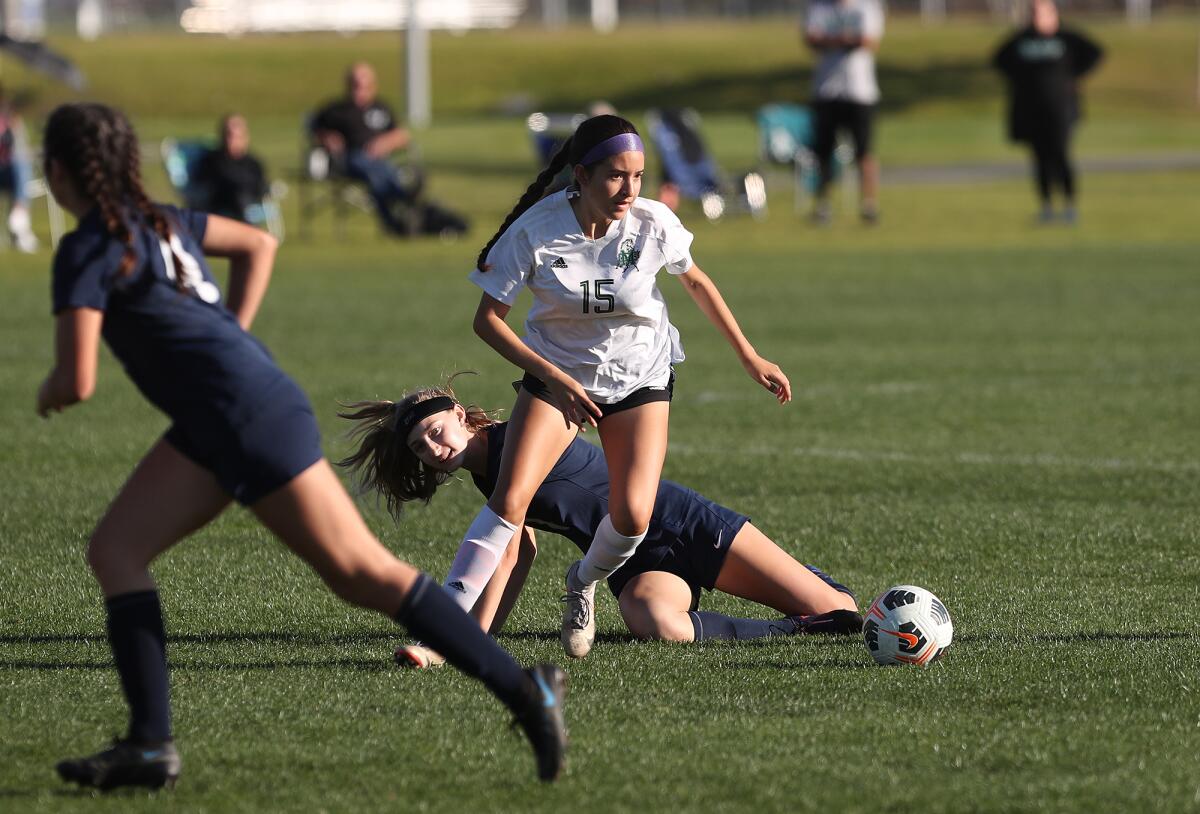 Costa Mesa's Brianna Calderon (15) makes a steal at midfield during a girls' soccer game against Calvary Chapel on Thursday.