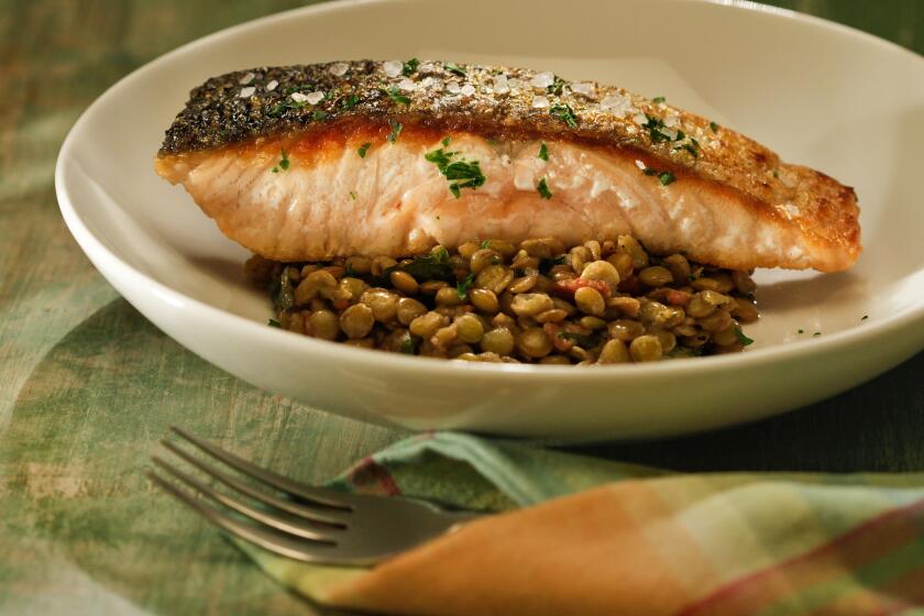 Recipe: Crisp-skinned salmon with lentils, bacon and dandelion greens