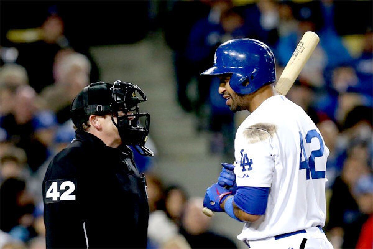 Matt Kemp has a word with home plate umpire Paul Schrieber after being called out on strikes in the seventh inning of the Dodgers' 6-3 loss to the Padres.