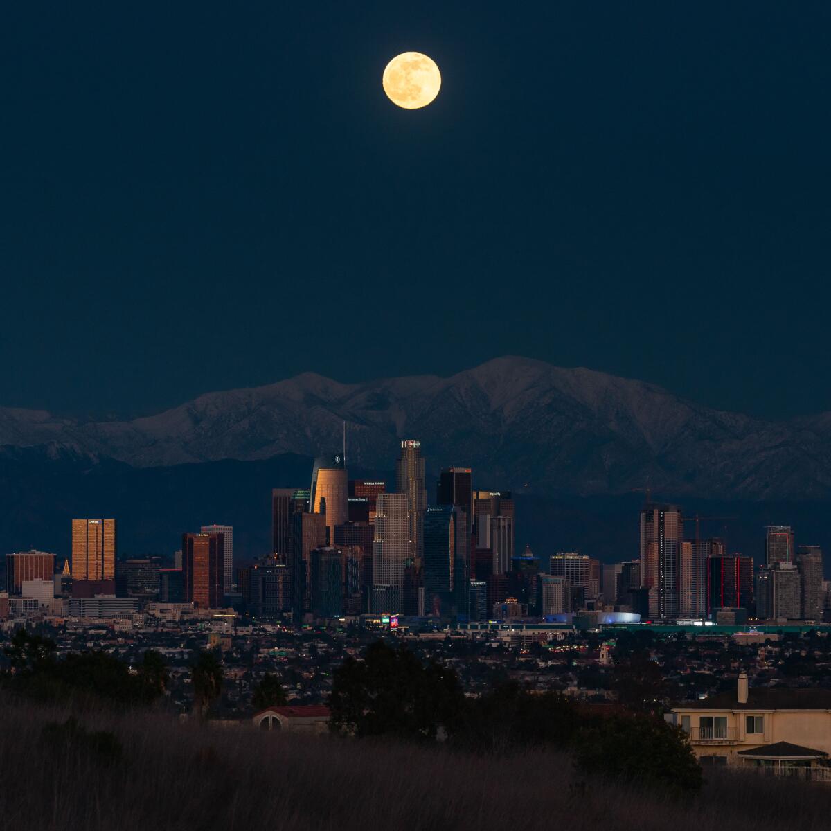 Light from a full moon reflects off buildings in the downtown L.A. skyline.