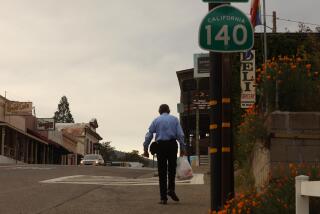 MARIPOSA, CA - APRIL 29, 2020 - - Bill Evans, 72, walks home along Highway 140 in the heart of Mariposa on April 29, 2020. Evans, a retired computer programmer, has been living in Mariposa since 2004. Most of the storefronts have been closed since Gov. Gavin Newsom announced in mid-March that all Californians were being required to shelter in place to reduce the spread of coronavirus. Mariposa County is one of five California counties that as of April 28 only had one reported coronavirus case, despite the fact all the surroundings have. A 23-year-old woman in Marioposa County had tested positive for COVID-190. More than 47,000 Californians have tested positive for the novel coronavirus but in Mariposa County, Tuesday's result was the first. (Genaro Molina / Los Angeles Times)