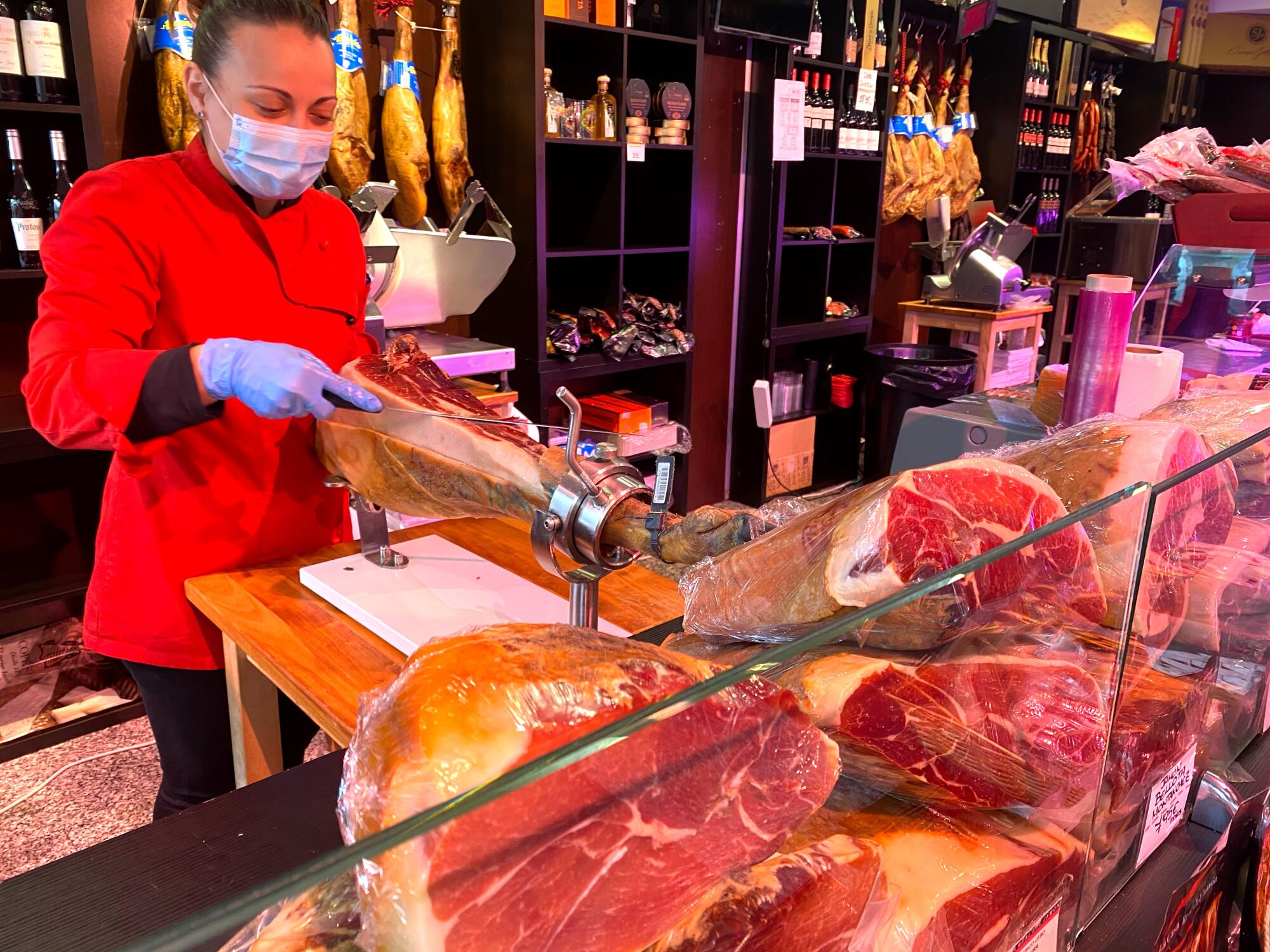 Iberian hams that were previously displayed outdoors are now shown behind display cabinets as an additional post-pandemic hygiene measure in Gijon, Spain.