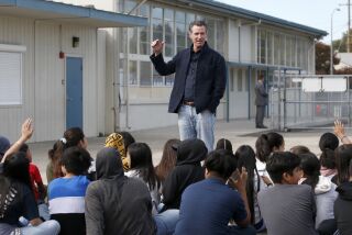 FILE - In this Oct. 7, 2019, file photo, California Gov. Gavin Newsom talks to students during his visit to the Ethel I. Baker Elementary School in Sacramento, Calif. Newsom said Friday, Oct. 30, 2020, his children are among those resuming in-person classes after months of distance learning due to the coronavirus pandemic. (AP Photo/Rich Pedroncelli, File )