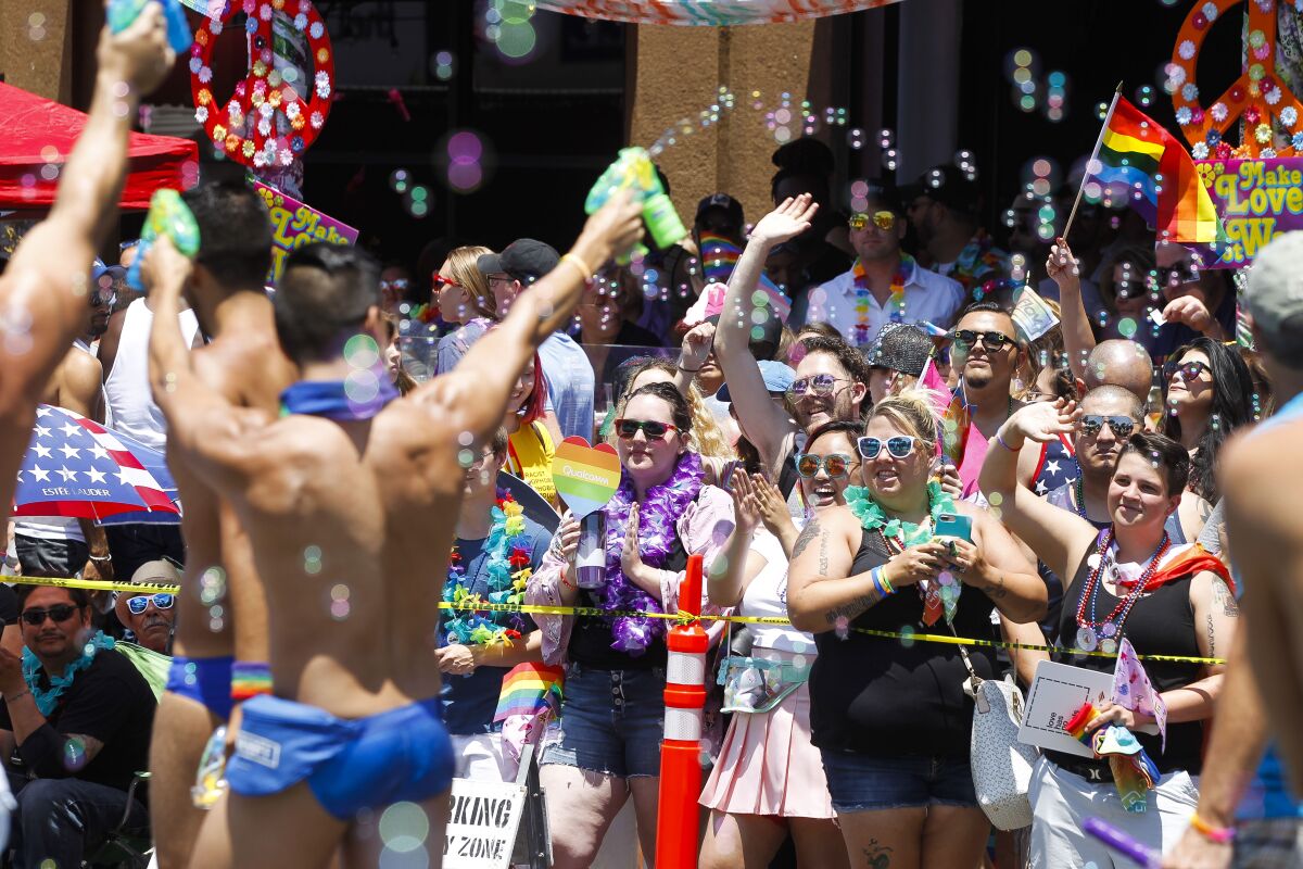 Spectators cheer on parade participants during the San Diego Pride Parade in San Diego in 2018.