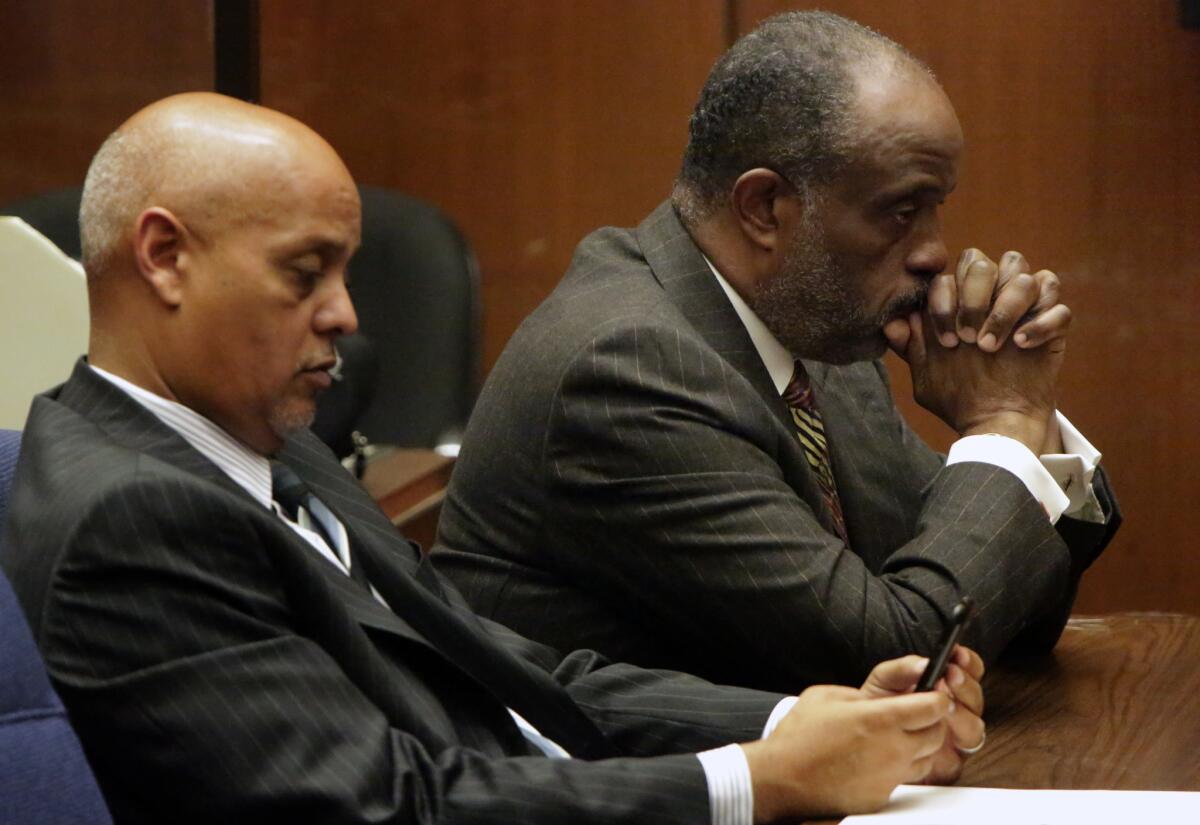 State Sen. Roderick Wright, right, flanked by his attorney Winston Kevin McKesson, listens to a judge after a jury convicted him this week of multiple fraud and perjury charges for living outside the district he was elected to represent.
