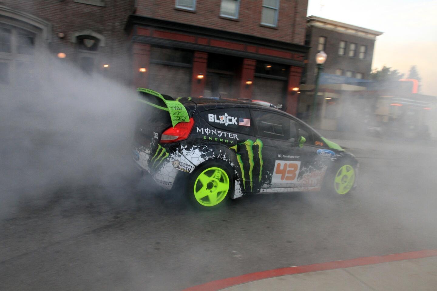 Stunt driver Ken Block drives around a Universal Studios lot in Los Angeles. After founding DC shoes and becoming a multimillionaire, Ken Block became a stunt driver. In one YouTube video, Block can be seen speeding down an empty Oakland Bay Bridge, ripping a set of tire-smoking doughnuts between two trolley cars, and seemingly breaking the laws of physics by twisting the car in mid-flight on a 90-degree turn after jumping a hill. Within 24 hours, the video was viewed more than 5 million times.