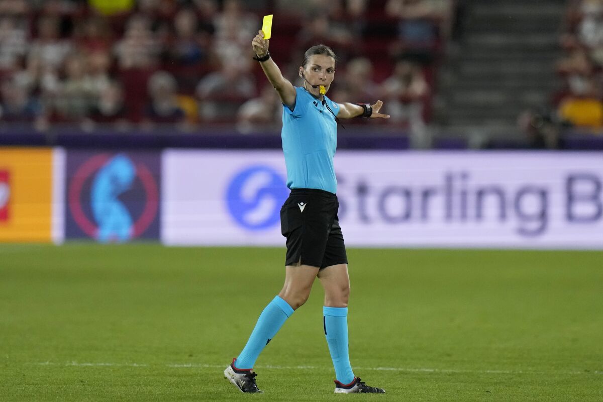 Referee Stephanie Frappart shows a yellow card during the Women Euro 2022 group B match between Germany and Spain.