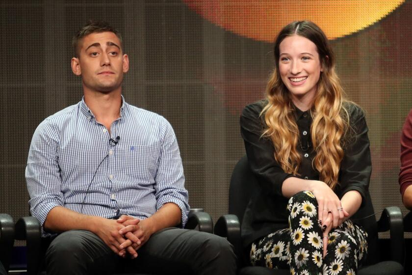 Actors Michael Socha and Sophie Lowe speak onstage during the "Once Upon a Time in Wonderland" panel.