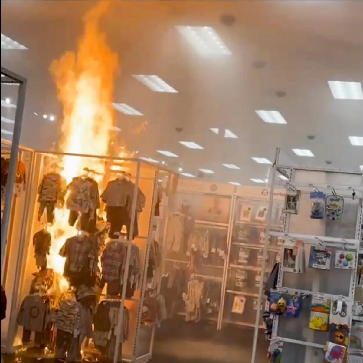 A fire blazes in a Target children's clothing section.