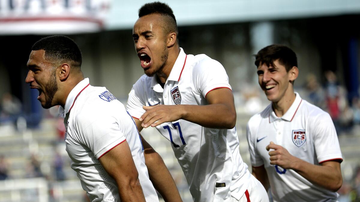 United States defender Cameron Carter-Vickers, left, celebrates with forward Jerome Kiesewetter (17) and midfielder Emerson Hyndman after scoring a goal against Cuba in the first half Satuday.